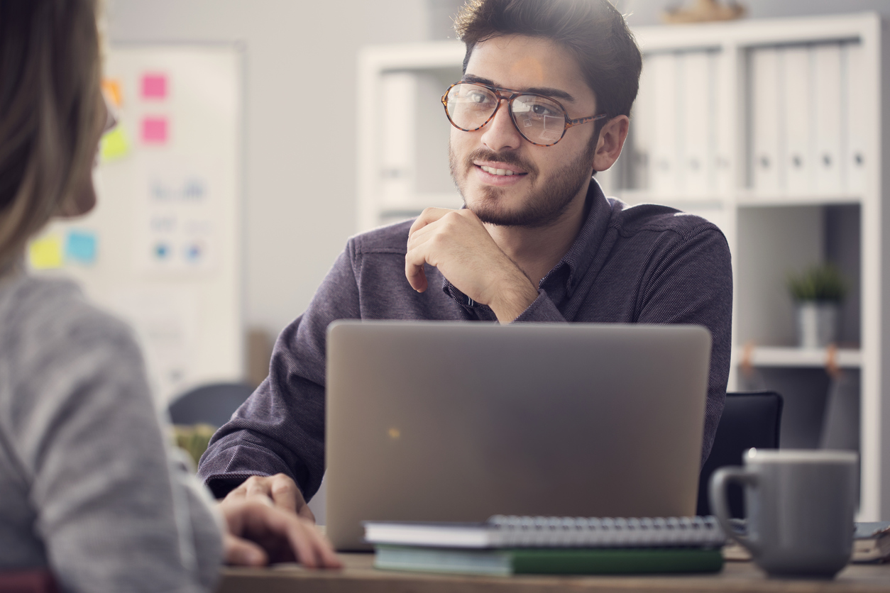 Young man listening a client in the office
