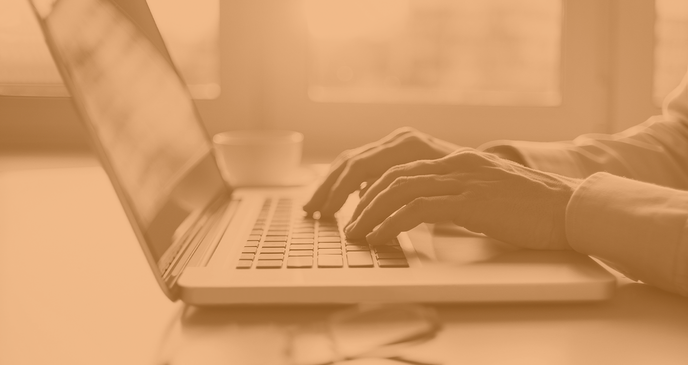 someone typing at a laptop